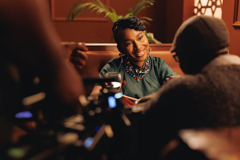 A smiling woman sharing advice across a table